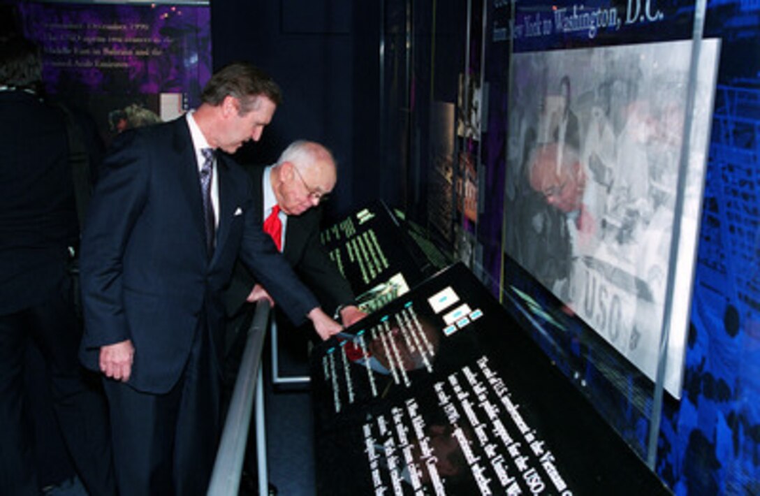 Secretary of Defense William S. Cohen (left) and Johnny Grant, honorary mayor of Hollywood, view the newly opened display of the United Service Organizations in the USO Corridor of the Pentagon on Nov. 2, 2000. The display commemorates the close relationship of the Department of Defense and the USO. 