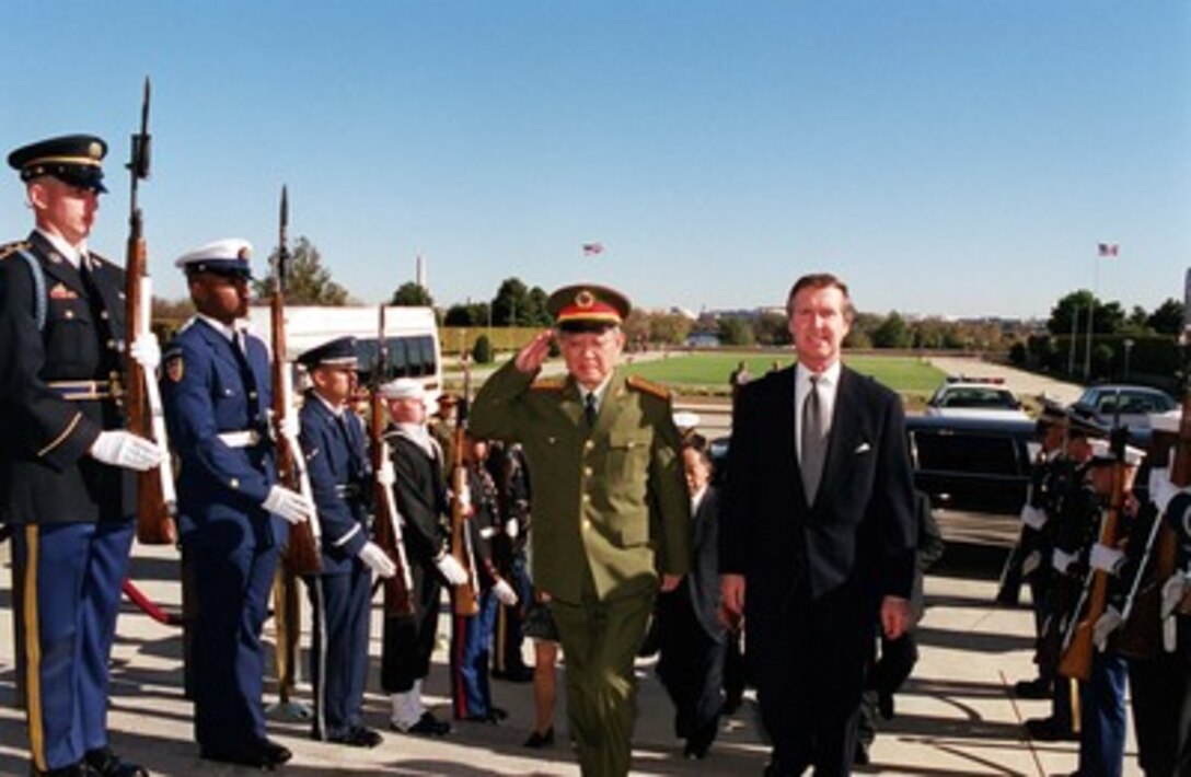 Secretary of Defense William S. Cohen (right) escorts Gen. Yu Yongbo (left), of the People's Republic of China Central Military Commission, into the Pentagon on Oct. 31, 2000. Cohen and Yu will meet to discuss items of interest to both nations. 