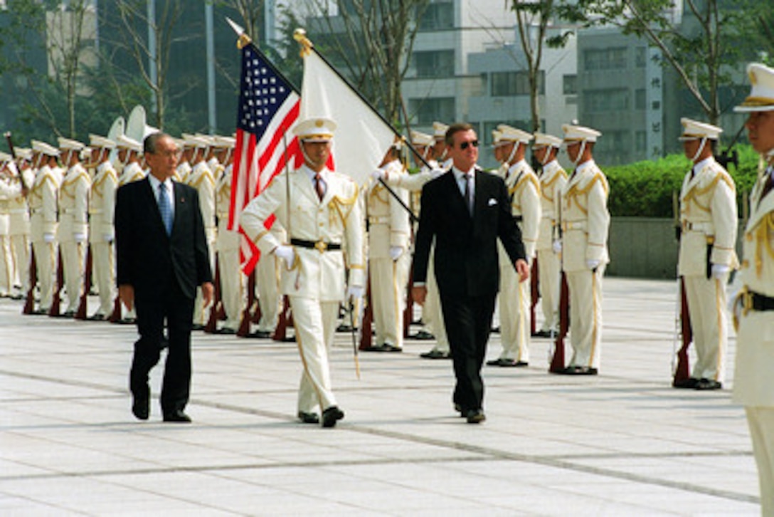 Minister of State for Defense Kazuo Torashima (left) escorts Secretary of Defense William S. Cohen (right) as he inspects the troops during a welcoming ceremony at the Japan Defense Agency Headquarters in Tokyo, Japan, on Sept. 22, 2000. Cohen is in Japan to meet with government officials and defense leaders. 