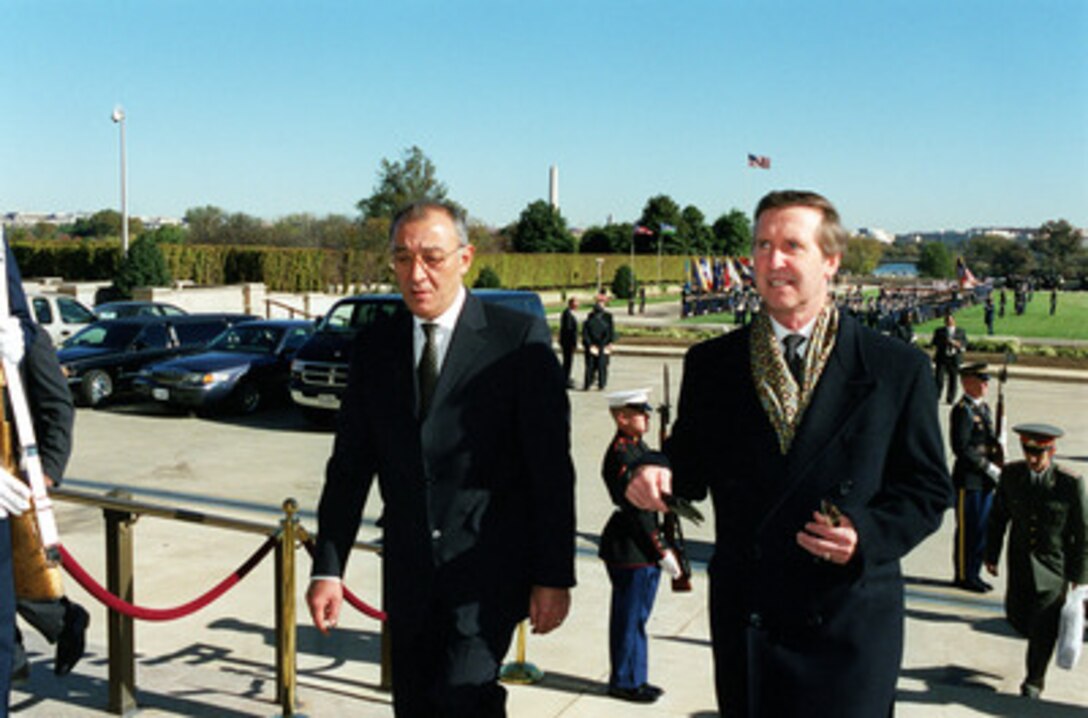 Secretary of Defense William S. Cohen (right) escorts Minister of Defense Kodir Ghulomov (left), of the Republic of Uzbekistan, into the Pentagon following a welcoming ceremony on Nov. 1, 2000. Cohen and Ghulomov will meet to discuss national and regional security issues of interest to the both nations. 