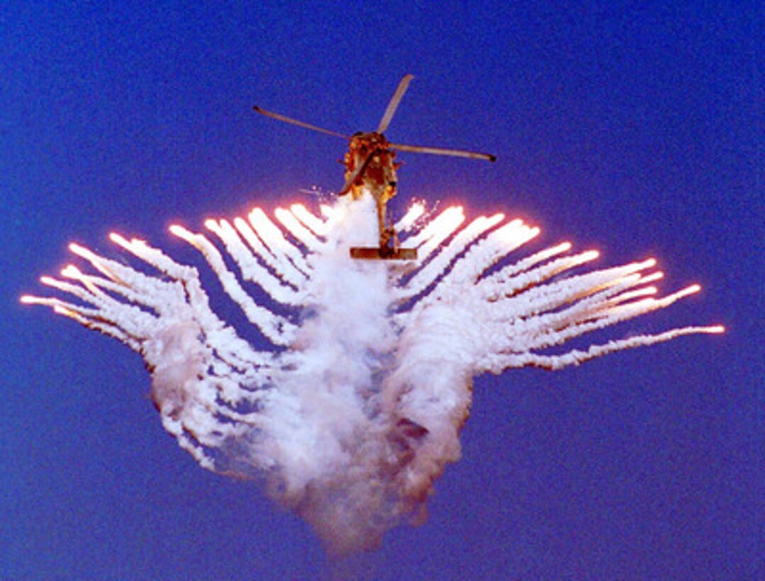 An SH-60 Sea Hawk helicopter fires flares during an air power demonstration performed by aircraft from the USS Kitty Hawk (CV 63) on Oct. 30, 2000. The Kitty Hawk is participating in Exercise Foal Eagle 2000, a U.S. and Republic of Korea combined forces exercise. The Sea Hawk is attached to Helicopter Anti-Submarine Squadron 14 of Naval Air Facility Atsugi, Japan. 