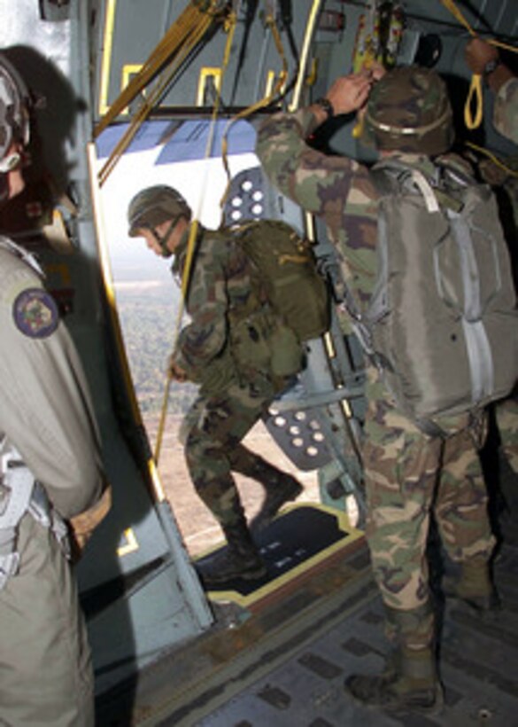 A soldier from the Army's 82nd Airborne exits out of an Air Force C-141B Starlifter over the Sicily Drop Zone at Fort Bragg, N.C., on Nov. 3, 2000. The jumper is one of 5,000 82nd Airborne troops taking part in an aerial assault exercise called Large Package Week. The quarterly training exercise sharpens the airdrop capability of aircrews from the Air Mobility Command and the 82nd Airborne. 