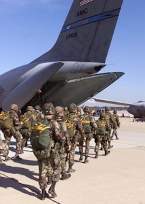 Soldiers of the 82nd Airborne load into an Air Force C-141B Starlifter at Pope Air Force Base, N.C., for their parachute jump over the Sicily Drop Zone at Fort Bragg, N.C., on Nov. 3, 2000. Five thousand 82nd Airborne troops are taking part in an aerial assault exercise called Large Package Week. The quarterly training exercise sharpens the airdrop capability of aircrews from the Air Mobility Command and the 82nd Airborne. 