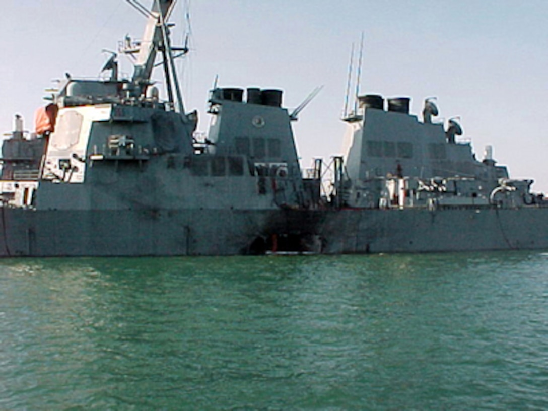 Port side view showing the damage sustained by the Arleigh Burke class guided missile destroyer USS Cole (DDG 67) on October 12, 2000, after a suspected terrorist bomb exploded during a refueling operation in the port of Aden, Yemen. USS Cole is on a regular scheduled six-month deployment. 