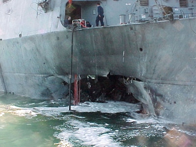 Port side view showing the damage sustained by the Arleigh Burke class guided missile destroyer USS Cole (DDG 67) on October 12, 2000, after a suspected terrorist bomb exploded during a refueling operation in the port of Aden, Yemen. USS Cole is on a regular scheduled six-month deployment.
