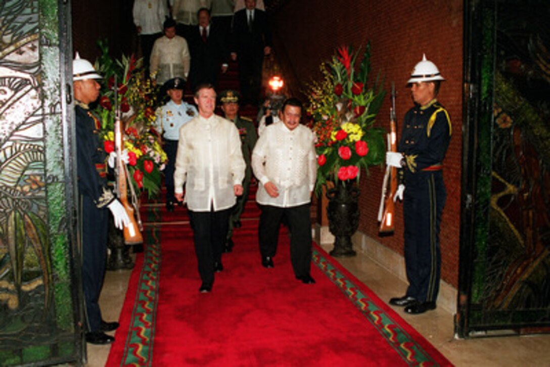 President Joseph Estrada (right) escorts Secretary of Defense William S. Cohen (left) as he departs Malacanang Palace following an official dinner on Sept. 15, 2000. Cohen traveled to the Republic of the Philippines to meet with officials to discuss issues of mutual interest. 