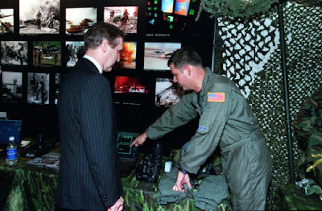 Secretary of Defense William S. Cohen is briefed on the steps used in still digital photography by today's combat photographer. This static display was part of the Pentagon reception and film preview of the Dreamworks film on combat cameramen "Shooting War" on Oct. 4, 2000. Secretary of Defense and Mrs. Cohen invited 250 defense leaders, commanders and corporate executives to the Department of Defense tribute to the military's past and present combat cameramen. 