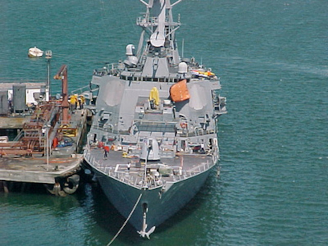The U.S. Navy guided missile destroyer USS Cole (DDG 67) remains moored to a refueling platform in the industrial harbor in Aden, Yemen, on Oct. 15, 2000. The Arleigh Burke class destroyer was the target of a suspected terrorist attack which took place in the port of Aden on Oct. 12, 2000, during a scheduled refueling. Nine sailors were killed and eight have been listed as missing. 