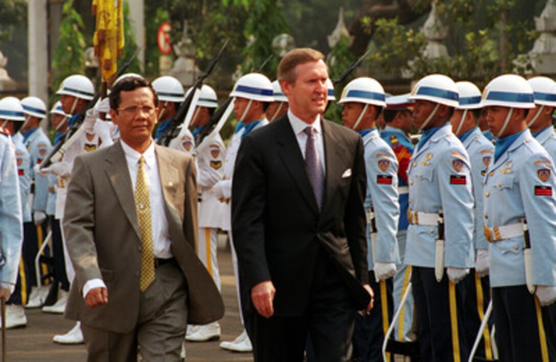 Minister of Defense Mahfud Mahmudin (left) escorts Secretary of Defense William S. Cohen (right) as he inspects the troops during an armed forces welcoming ceremony on Sept. 18, 2000, at the Defense Ministry in Jakarta, Indonesia. Cohen is on a Southeast Asia trip to meet with government and defense leaders. 