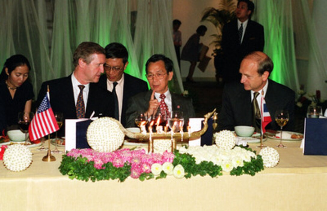 Prime Minister Chuan Likphai (center) hosts a dinner welcoming Secretary of Defense William S. Cohen (left) to the Kingdom of Thailand on Sept. 18, 2000. U.S. Ambassador to Thailand Richard Hecklinger (right) joined Likphai and Cohen as they discussed issues of interest to both nations. 