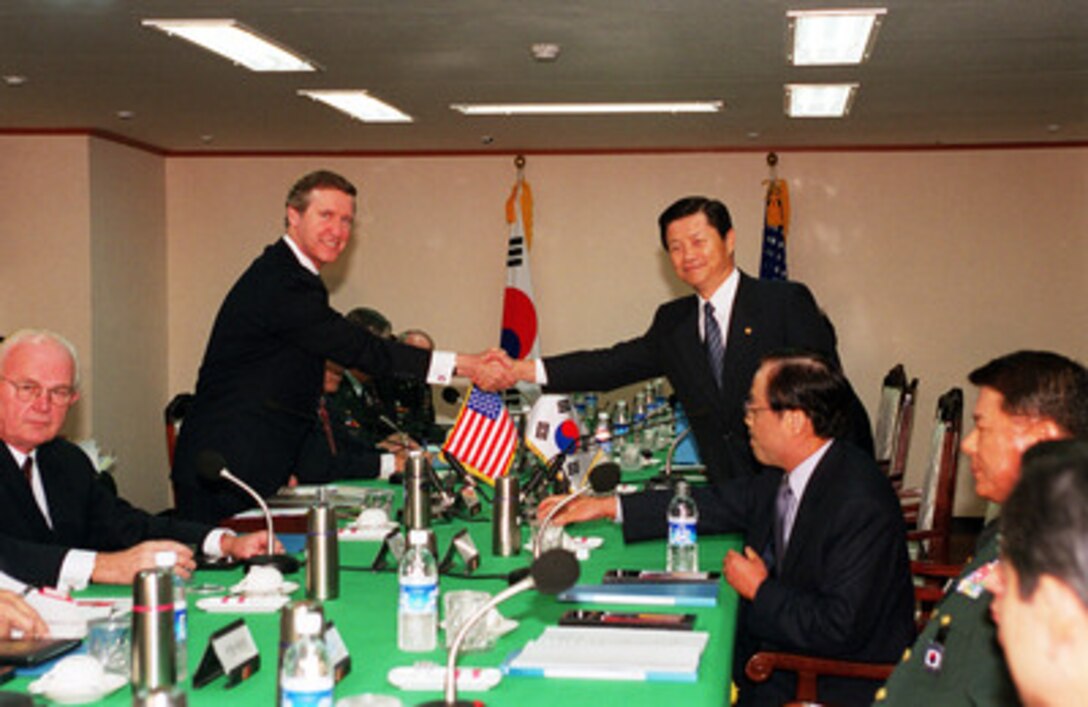 Secretary of Defense William S. Cohen (left) and Republic of Korea Minister of National Defense Cho Seong Tae (right) shake hands for photographers at the beginning of the 32nd ROK-U.S. Security Consultative Meeting held in Seoul on Sept. 21, 2000. Cohen is on a Southeast Asia trip to meet with government and defense leaders. 