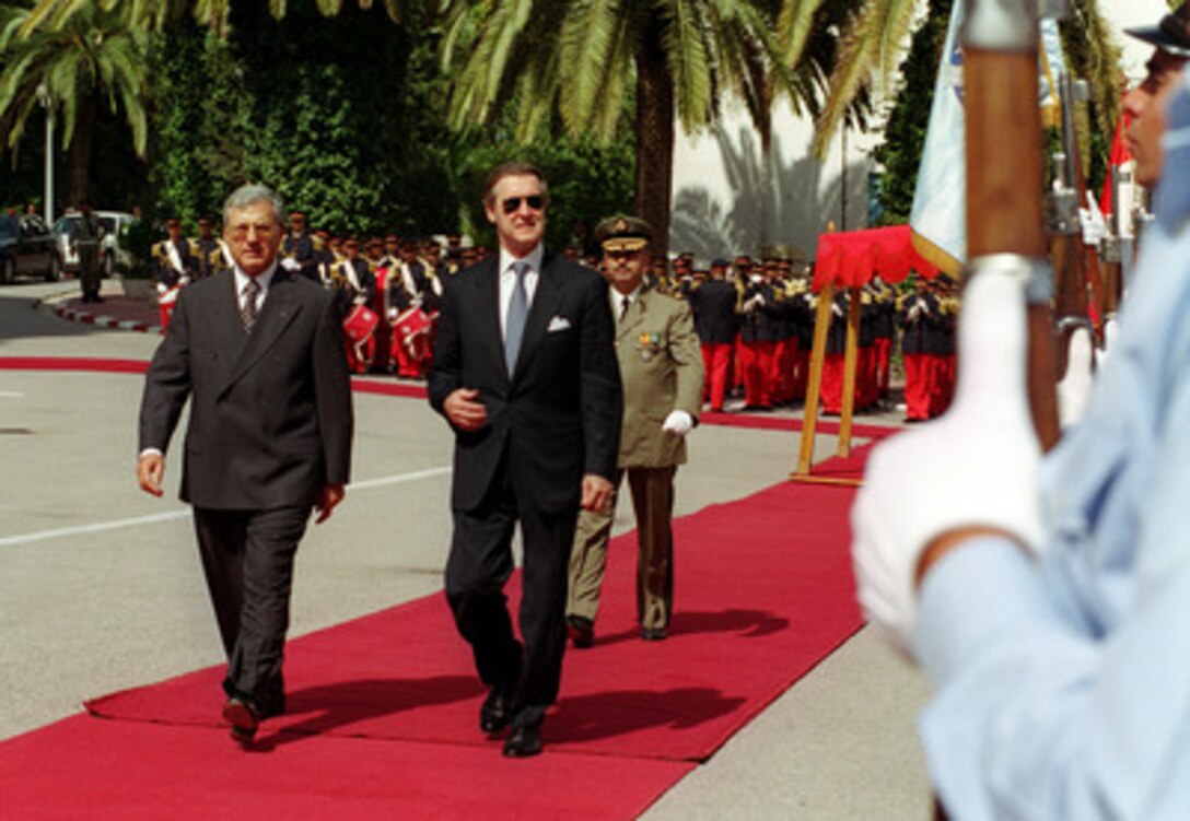 Tunisian Minister of Defense Mohamed Jegham (left), escorts Secretary of Defense William S. Cohen (right) as he inspects the honor guard at the Ministry of Defense in Tunis, Tunisia, on Oct. 7, 2000. Cohen will meet with Jegham to discuss a range of regional security issues of interest to both nations. Cohen's stop in Tunisia came at the start of a three nation visit which will also take him to Greece and the United Kingdom. 