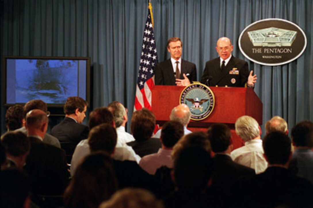 Chief of Naval Operations Adm. Vern Clark (right), U.S. Navy, joins Secretary of Defense William S. Cohen (left) in briefing reporters at the Pentagon about the suspected terrorist attack on the USS Cole (DDG 67) in Aden, Yemen, on Oct. 12, 2000. Cohen reported that five sailors were confirmed dead, 36 wounded and 12 missing, though he believed those figures would change as work in the damaged ship continued. 