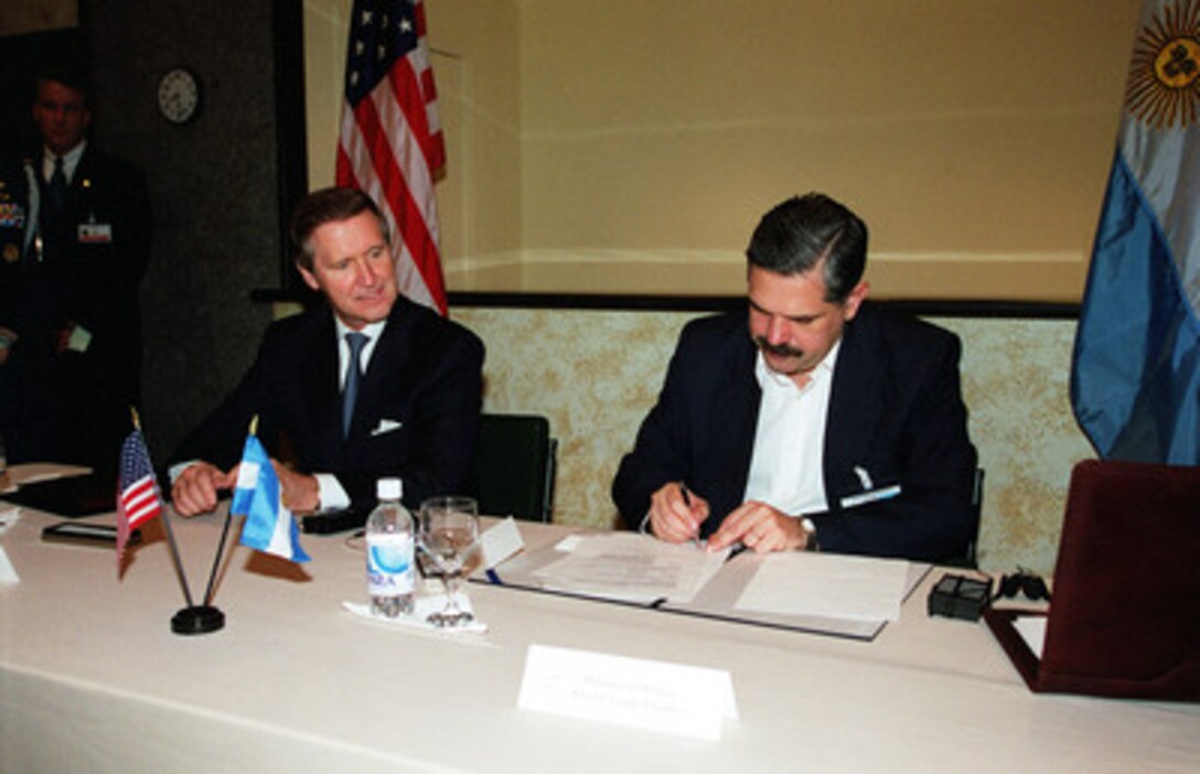 Secretary of Defense William S. Cohen (left) and Argentinian Minister of Defense Ricardo Lopez Murphy (right) sign an agreement in Manaus, Brazil, on Oct. 17, 2000, concerning the exchange of research and development information. The agreement allows the two nations to share sensitive information on a wide range of subjects including arms programs, acquisition and terrorism. The defense leaders are in Manaus attending the Defense Ministerial of the Americas IV. 