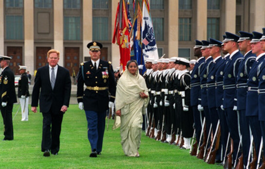 Prime Minister Sheikh Hasina (right), of the Peoples Republic of Bangladesh, is escorted by Commander of Troops Col. Thomas M. Jordan (center), U.S. Army, and Deputy Secretary of Defense Rudy de Leon (left) as she inspects the ceremonial honor guard during a full honor arrival ceremony at the Pentagon on Oct. 17, 2000. Hasina, who also serves as her nation's defense minister, and de Leon will meet for talks on a broad range of security issues of interest to both nations. 