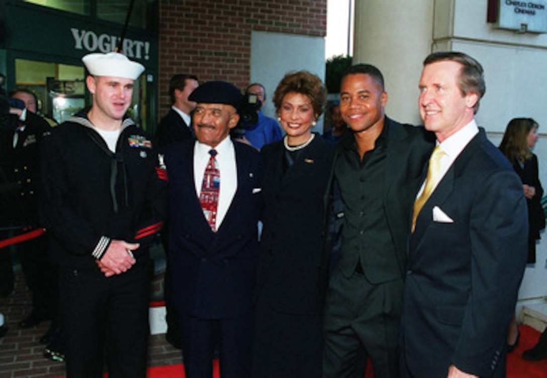 Navy Petty Officer First Class Eric Tilford (left), retired Navy Master Chief Carl M. Brashear (2nd from left), Janet Langhart Cohen (center), Cuba Gooding Jr. (2nd from right) and Secretary of Defense William S. Cohen (right) pose for pictures at a special premiere screening of the Twentieth Century Fox film "Men of Honor" in Washington, D.C., on Oct. 21, 2000. The film was inspired by the Navy experiences of Brashear, who overcame adversity and racial prejudice in the newly integrated Navy of the 1950's, to become the Navy's first African-American deep sea diver. Tilford, a photographer's mate and Navy diver from Lamoni, Iowa, met Brashear while attending Navy dive school nearly 10-years ago, but did not realize at the time he was one of the Navy's unsung heroes. Gooding plays the role of Brashear in the film. 