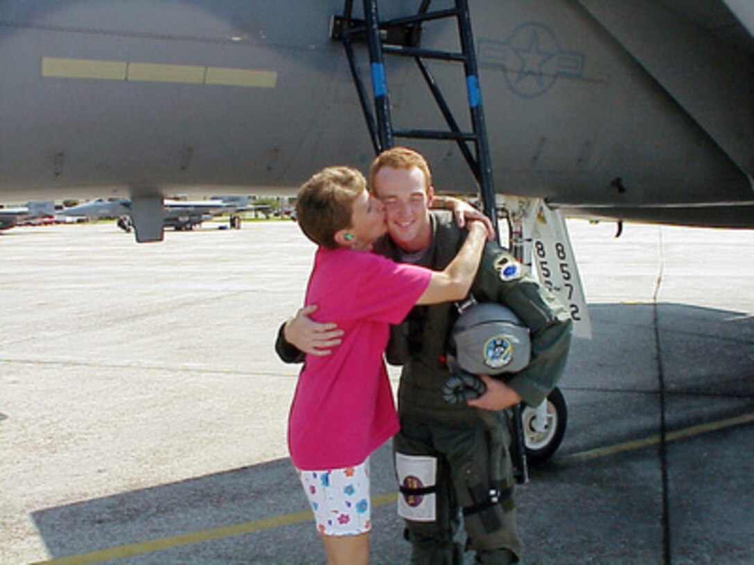 Lori Zimmerman kisses her son Dale Zimmerman after he completed his orientation flight in an F-15 Eagle at Tyndall Air Force Base, Fla., on Aug. 24, 2000. Dale is the Air Force winner of the Yahoo! Fantasy Careers in Today's Military Contest and is spending a two-day adventure as an honorary F-15 pilot. Zimmerman, 22, from Junction City, Ore., is a customer service representative for United Airlines. 