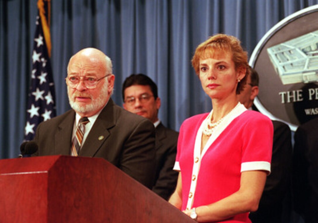 Robert C. Shinn, Jr. (left) commissioner of the New Jersey Department of Environmental Protection, and Deputy Under Secretary of Defense for Environmental Security Sherri Goodman (right) respond to reporter's questions in the Pentagon after signing an agreement for the environmental cleanup of multiple military sites in the State of New Jersey, on Aug. 30, 2000. 
