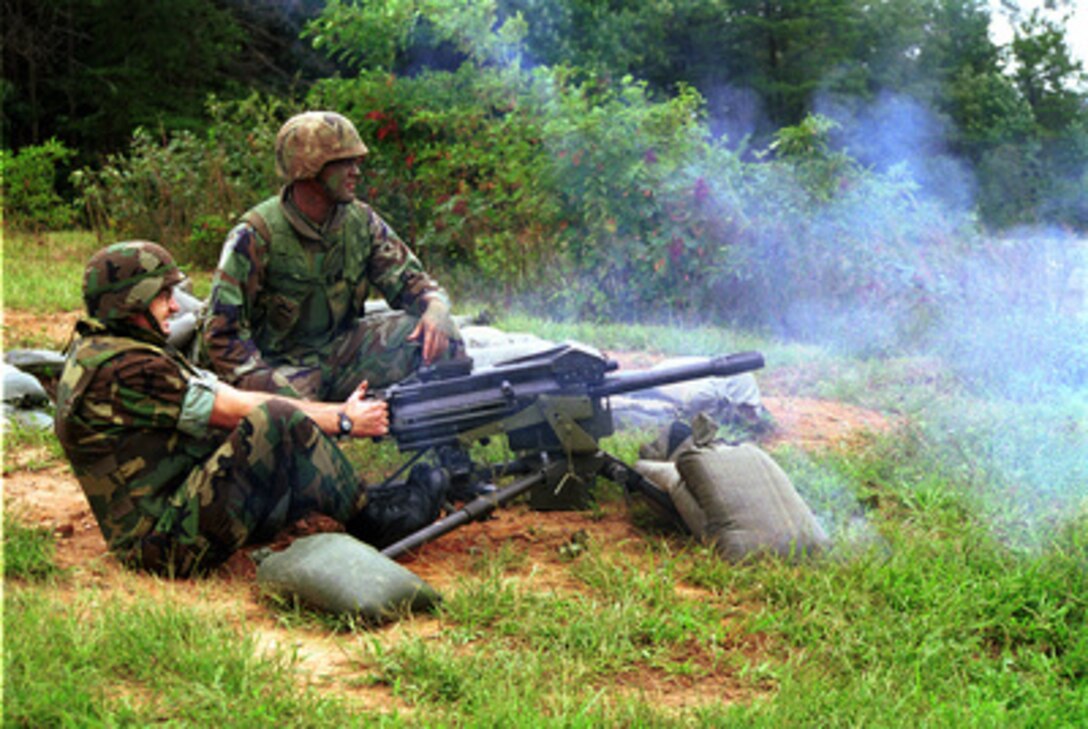 Richard Castanet (left) fires a Mark-19 automatic grenade launcher on Range 6 at Marine Corps Base Quantico, Va., on Sept. 5, 2000. Castanet, from Richmond, Va., is the Marine winner of the Yahoo! Fantasy Careers in Today's Military Contest. 