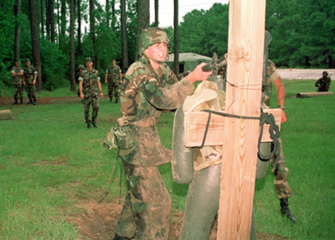Christian Castanet attacks a simulated enemy during training on the Individual Movement Course at Parris Island Recruit Training Depot, S.C., on Sept. 6, 2000. Castanet is the son of Richard A. Castanet, from Richmond, Va., who is the Marine winner of the Yahoo! Fantasy Careers in Today's Military Contest. Father and son are experiencing Marine Corps training together. 