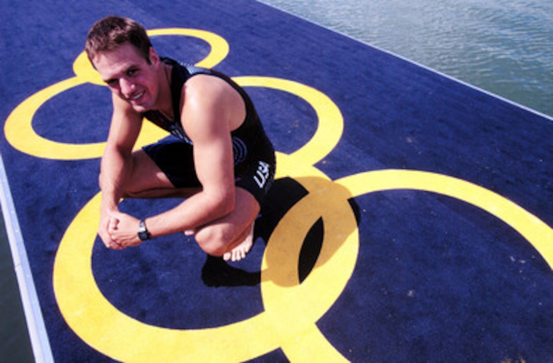 Navy Ensign Henry Nuzum poses in one of the Olympic rings painted on the dock at the Sydney International Regatta Center before the 2000 Olympic Games in Sydney, Australia, on Sept. 15, 2000. Nuzum, along with his rowing partner Mike Ferry, will compete in the double sculls on the 2,000 meter Olympic course. Fifteen U.S. military athletes are competing in the 2000 Olympic games as members of the U.S. Olympic team. In addition to the 15 competing athletes there are eight alternates and five coaches representing each of the four services in various venues. 