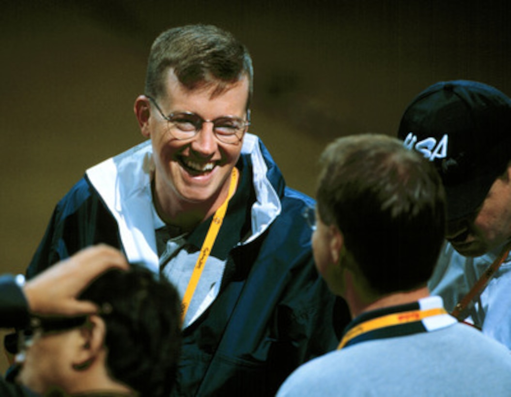 Army Staff Sgt. Ken Johnson, of the U.S. Olympic shooting team, smiles after his wife Nancy won the first gold medal for the women's 10 meter air rifle competition at the 2000 Olympic Games in Sydney, Australia, on Sept. 16, 2000. Nancy Johnson's gold medal is the first awarded in the Sydney Games and the first gold for the U.S. Husband Ken will compete in the men's 10 meter air rifle competition later in the games. Fifteen U.S. military athletes are competing in the 2000 Olympic games as members of the U.S. Olympic team. 