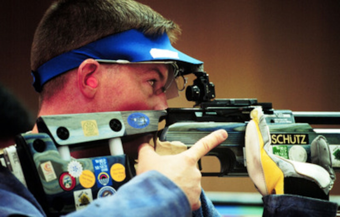 Army Staff Sgt. Kenneth A. Johnson peers through the sight of his air rifle as competes in the men's 10 meter air rifle competition at the 2000 Olympic Games in Sydney, Australia, on Sept. 18, 2000. Fifteen U.S. military athletes are competing in the 2000 Olympic games as members of the U.S. Olympic team. In addition to the 15 competing athletes there are eight alternates and five coaches representing each of the four services in various venues. Johnson is attached to the U.S. Army Marksmanship Unit, Fort Benning, Ga. 
