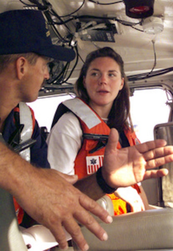 Stephanie Kelley listens intently to Petty Officer 2nd Class Patrick Reinhart, U.S. Coast Guard, as he explains how to operate the controls of Coast Guard Station Galveston's 47-foot motor surf boat on Sept. 12, 2000, near Galveston, Texas. Kelley, 22, from Stow, Mass., is the Coast Guard winner of the Yahoo! Fantasy Careers in Today's Military Contest. The Duke University graduate is experiencing a day in the life of a boat crew as part of the contest. 