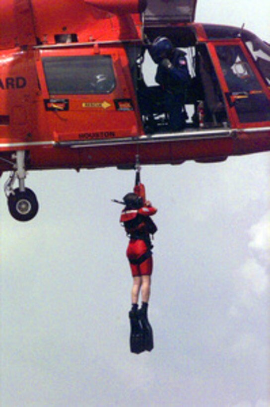 Stephanie Kelley dangles from the rescue winch of a U.S. Coast Guard HH-65A Dolphin helicopter after being plucked from the waters of the Gulf of Mexico on Sept. 14, 2000. Kelley, 22, from Stow, Mass., is the Coast Guard winner of the Yahoo! Fantasy Careers in Today's Military Contest. The Duke University graduate is experiencing a day in the life of a rescue swimmer at Air Station Houston as part of the contest. 