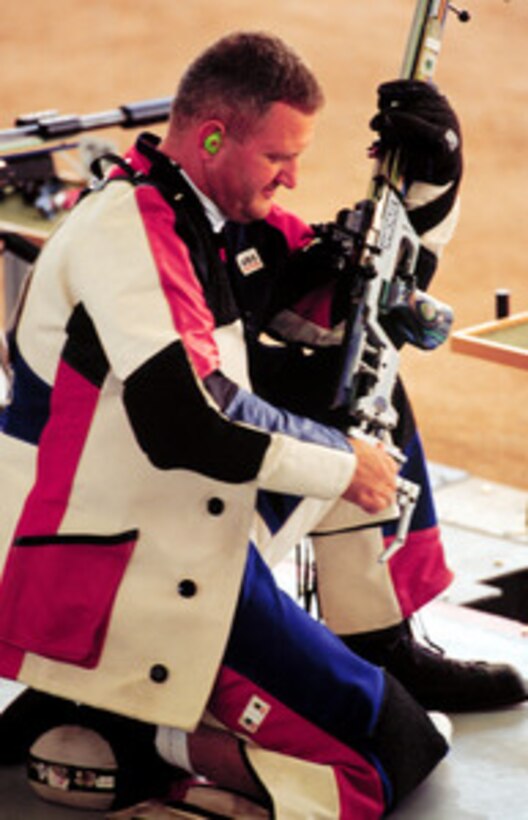 Capt. Glenn A. Dubis prepares to shoot from the kneeling position during qualifications for the Men's 50 meter rifle three position on Sept. 23, 2000 at the 2000 Olympic Games in Sydney, Australia. Dubis is one of fifteen U.S. military athletes competing in the 2000 Olympic games as members of the U.S. Olympic team. In addition to the 15 competing athletes there are eight alternates and five coaches representing each of the four services in various venues. Dubis is attached to the U.S. Army Marksmanship Unit, Fort Benning, Ga. 