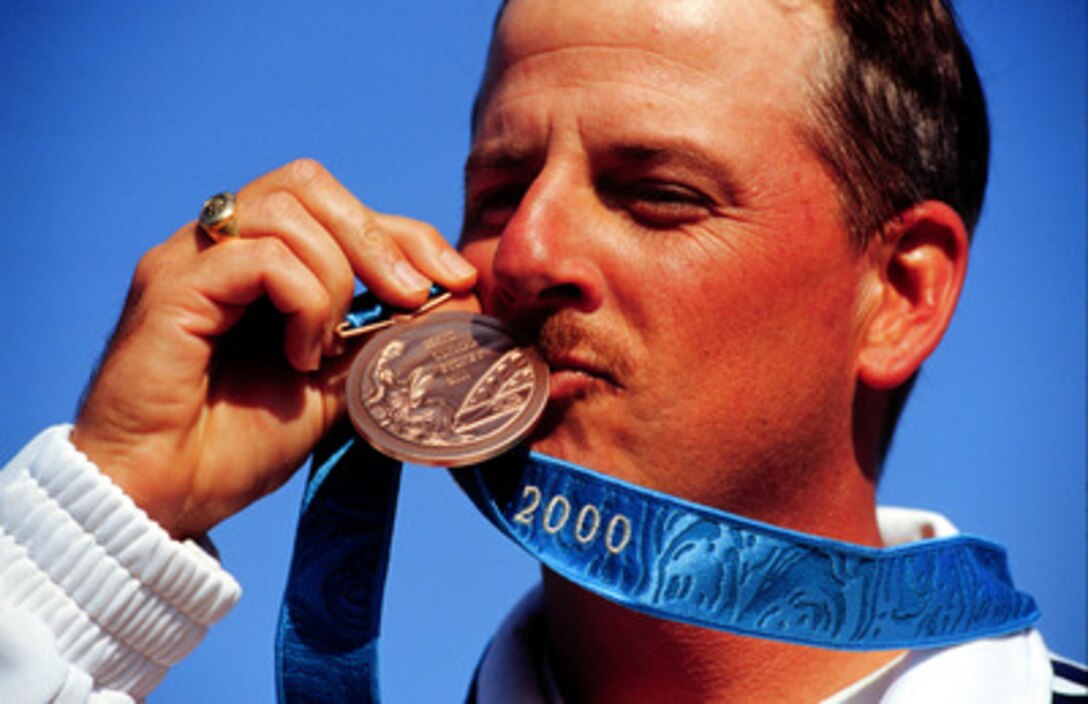 Sgt. 1st Class James T. Graves kisses the bronze medal he won in the Men's Skeet competition at the 2000 Olympic Games in Sydney, Australia, on Sept. 23, 2000. Graves is one of fifteen U.S. military athletes competing in the 2000 Olympic games as members of the U.S. Olympic team. In addition to the 15 competing athletes there are eight alternates and five coaches representing each of the four services in various venues. Graves is attached to the U.S. Army Marksmanship Unit, Fort Benning, Ga. 