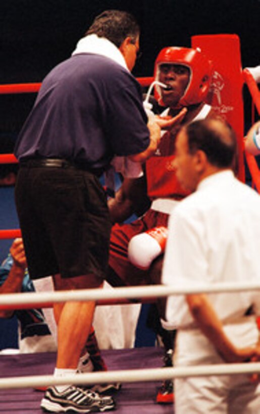 Staff Sgt. Olanda Anderson drinks some water as he sits in the red corner during his bout with Rudolf Kraj, of the Czech Republic, in the men's light heavyweight boxing match at the 2000 Olympic Games in Sydney, Australia, on Sept. 24, 2000. Anderson is one of fifteen U.S. military athletes competing in the 2000 Olympic games as members of the U.S. Olympic team. In addition to the 15 competing athletes there are eight alternates and five coaches representing each of the four services in various venues. Andersen, who is stationed at Fort Carson, Colo., lost to Kraj 12-13. 