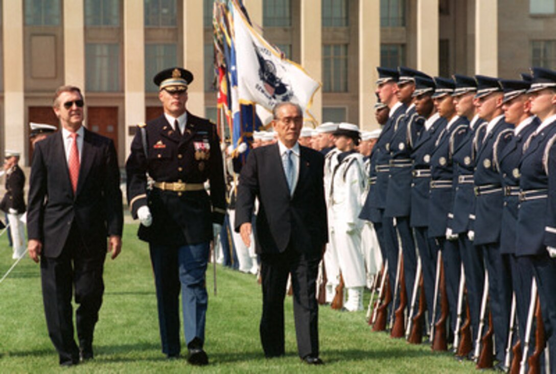 Director General of the Japan Defense Agency Kazuo Torashima (right) is escorted by Commander of Troops Col. Thomas Jordan (center), U.S. Army, and Secretary of Defense William S. Cohen (left) as he inspects the joint services honor guard at the Pentagon on Sept. 12, 2000. Torashima and Cohen will meet to discuss a range of security issues of interest to both nations. 