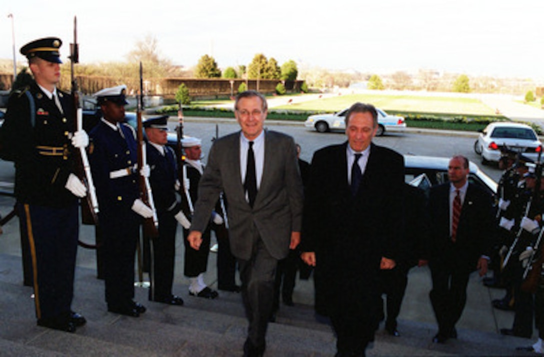 Secretary of Defense Donald H. Rumsfeld (left) escorts Minister of Foreign Affairs Ismail Cem, of Turkey, through an honor cordon and into the Pentagon on March 30, 2001. The two defense leaders will hold discussions on regional security issues of interest to both nations. 