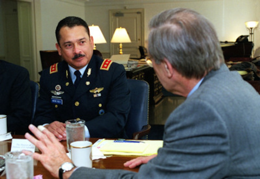 Minister of Defense Maj. Gen. Juan Antonio Martinez Varela, of El Salvador, meets with Secretary of Defense Donald H. Rumsfeld in the Pentagon on March 30, 2001. The two defense leaders are discussing regional security issues of interest to both nations. 