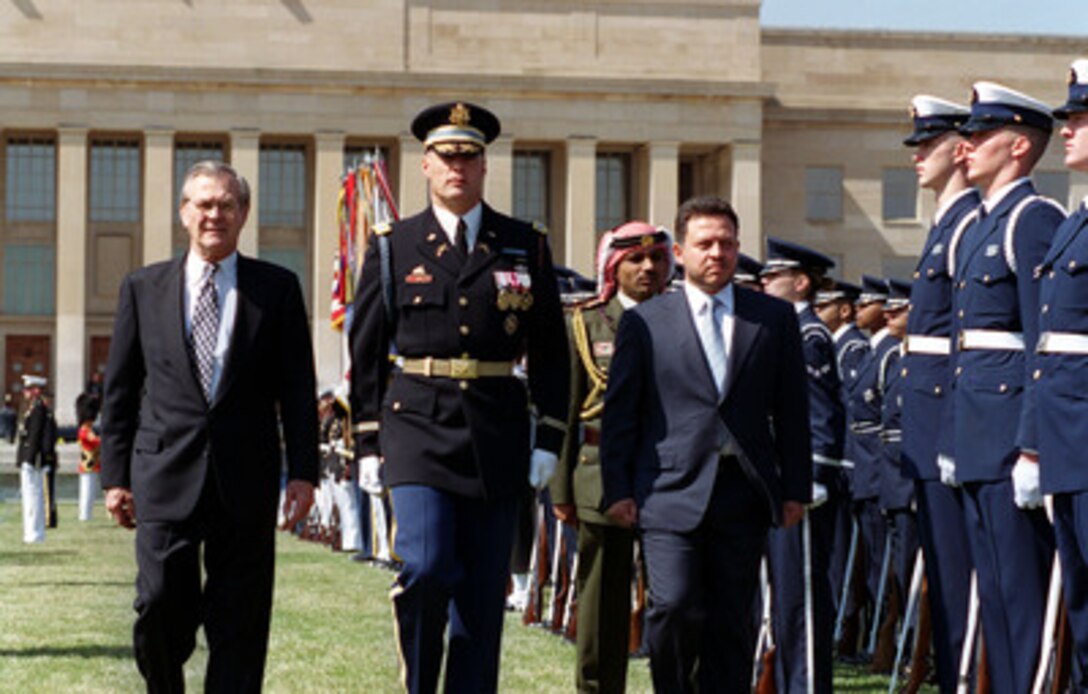 Secretary of Defense Donald H. Rumsfeld (left) and Commander of Troops Col. Thomas M. Jordan (center), U.S. Army, escort King Abdullah II (right), of the Hashemite Kingdom of Jordan, as he inspects the honor guard during a Pentagon welcoming ceremony on April 5, 2001. Accompanying the King is Prince Ali Bin al-Hussein, Chief of the Royal Guard. 