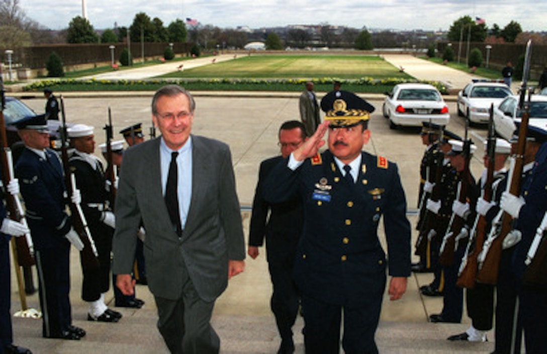 Secretary of Defense Donald H. Rumsfeld (left) escorts Minister of Defense Maj. Gen. Juan Antonio Martinez Varela, of El Salvador, through an honor cordon and into the Pentagon on March 30, 2001. The two defense leaders will hold discussions on regional security issues of interest to both nations. 