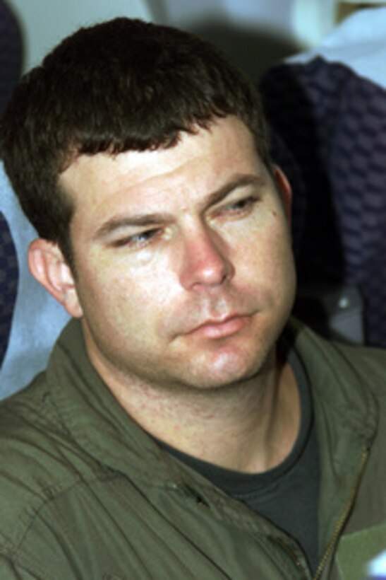 An exhausted Petty Officer 2nd Class Scott Guidry listens to a member of the repatriation crew aboard a chartered aircraft which will fly him from Haikou, China, to Guam, on April 12, 2001, during Operation Valiant Return. Guidry, a Navy Electronics Technician, is one of 24 crew members detained for 11 days after their EP-3 Aries II reconnaissance aircraft made forced landing on Hainan Island as a result of a collision with a Chinese F-8 fighter aircraft. The crew will stop briefly in Guam to change planes and will then continue on to Hawaii for military debriefings before a final reunion with families and friends on the mainland. Guidry is from Satellite Beach Brevard, Fla. 