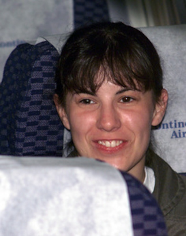 Navy Lt. j.g. Regina Kauffman is elated after boarding a chartered aircraft which will fly her from Haikou, China, to Guam, on April 12, 2001, during Operation Valiant Return. Kauffman is one of 24 crew members detained for 11 days after their EP-3 Aries II reconnaissance aircraft made forced landing on Hainan Island as a result of a collision with a Chinese F-8 fighter aircraft. The crew will stop briefly in Guam to change planes and will then continue on to Hawaii for military debriefings before a final reunion with families and friends on the mainland. Kauffman is from Warminster, Pa. 