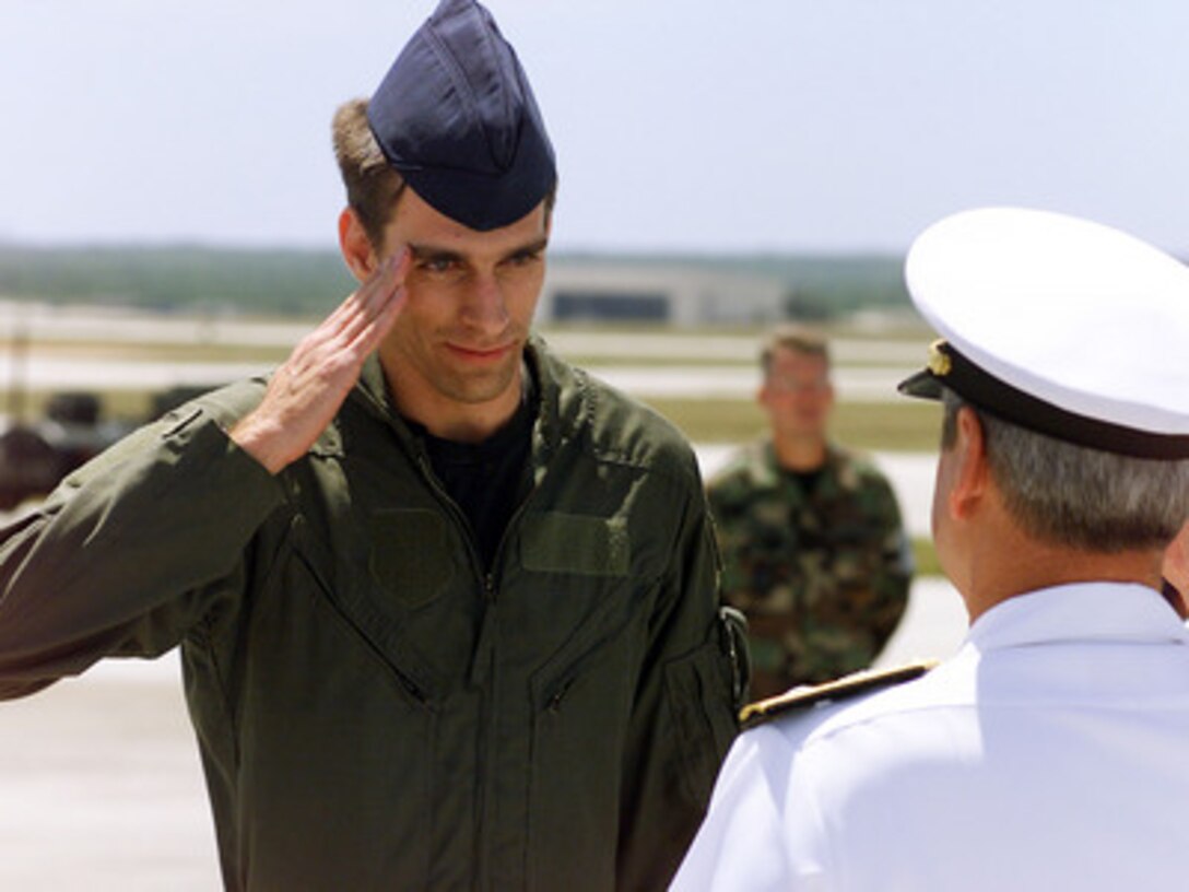 Air Force Senior Airman Curtis Towne salutes as he goes through a receiving line after arriving at Andersen Air Force Base, Guam, on April 12, 2001, during Operation Valiant Return. Towne is one of 24 crew members detained for 11 days after their EP-3 Aries II reconnaissance aircraft made forced landing on Hainan Island as a result of a collision with a Chinese F-8 fighter aircraft. The crew is stopping briefly in Guam to change planes and will then continue on to Hawaii for military debriefings before a final reunion with families and friends on the mainland. Towne is from Haywood, Calif. 