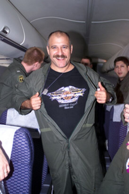 Senior Chief Petty Officer Nicholas Mellos shows off his tee-shirt emblazoned with the phrase "An American Legend" as he begins his celebration aboard a chartered aircraft after being released at Haikou, China, on April 12, 2001, during Operation Valiant Return. Mellos, a Navy Aviation Machinist's Mate, is one of 24 crew members detained for 11 days after their EP-3 Aries II reconnaissance aircraft made forced landing on Hainan Island as a result of a collision with a Chinese F-8 fighter aircraft. The crew will stop briefly in Guam to change planes and will then continue on to Hawaii for military debriefings before a final reunion with families and friends on the mainland. Mellos is from Ypsilanti, Mich. 