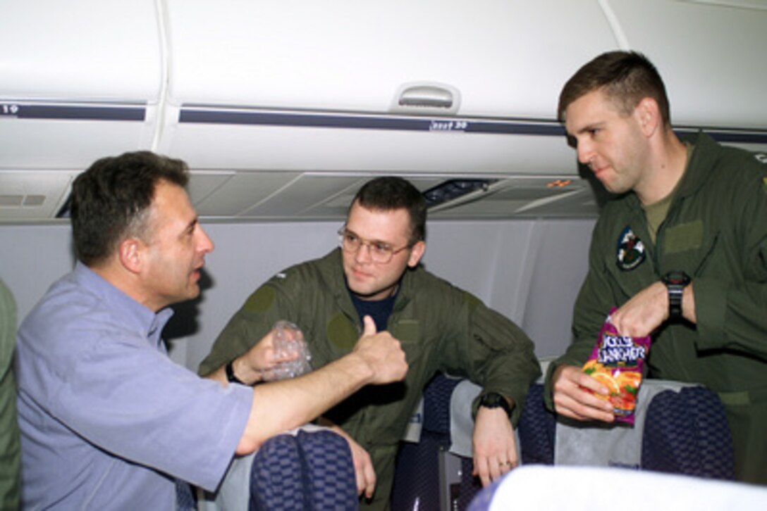 Lts. Patrick Honeck (center) and Richard Payne (right) listen to Navy Cmdr. Benard Lessard (left) aboard a chartered aircraft after being released at Haikou, China, on April 12, 2001, during Operation Valiant Return. Honeck and Payne are two of 24 crew members detained for 11 days after their EP-3 Aries II reconnaissance aircraft made forced landing on Hainan Island as a result of a collision with a Chinese F-8 fighter aircraft. The crew will stop briefly in Guam to change planes and will then continue on to Hawaii for military debriefings before a final reunion with families and friends on the mainland. Honeck is from La Mesa, Calif. Lessard is the commanding officer of Fleet Air Reconnaissance Squadron 1. 