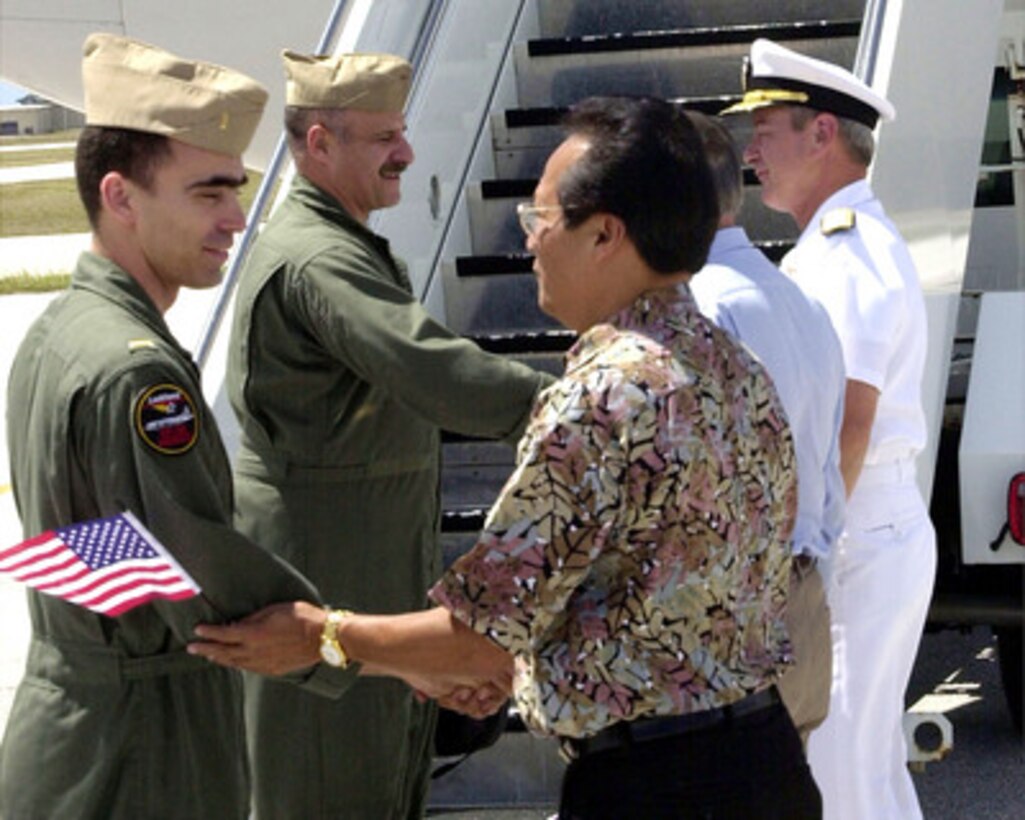Navy Ens. Richard Bensing (left) and Senior Chief Petty Officer Nicholas Mellos (2nd from left) go through a receiving line after arriving at Andersen Air Force Base, Guam, on April 12, 2001, during Operation Valiant Return. Bensing and Mellos are two of 24 crew members detained for 11 days after their EP-3 Aries II reconnaissance aircraft made forced landing on Hainan Island as a result of a collision with a Chinese F-8 fighter aircraft. The crew is stopping briefly in Guam to change planes and will then continue on to Hawaii for military debriefings before a final reunion with families and friends on the mainland. Bensing is from Brandon, Fla., while Mellos is from Ypsilanti, Mich. 