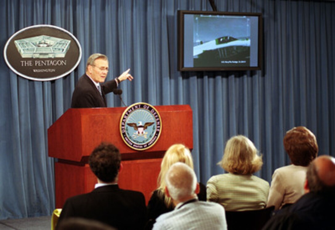 010413-D-9880W-036  Secretary of Defense Donald H. Rumsfeld comments on a videotape shown to reporters during a press briefing in the Pentagon on April 13, 2001. Rumsfeld is using the video as an example of previous close encounters between U.S. aircraft and Chinese fighters. The secretary is briefing reporters on the facts associated with the recent collision of the EP-3 Aries II reconnaissance aircraft and the Chinese F-8 fighter aircraft. 