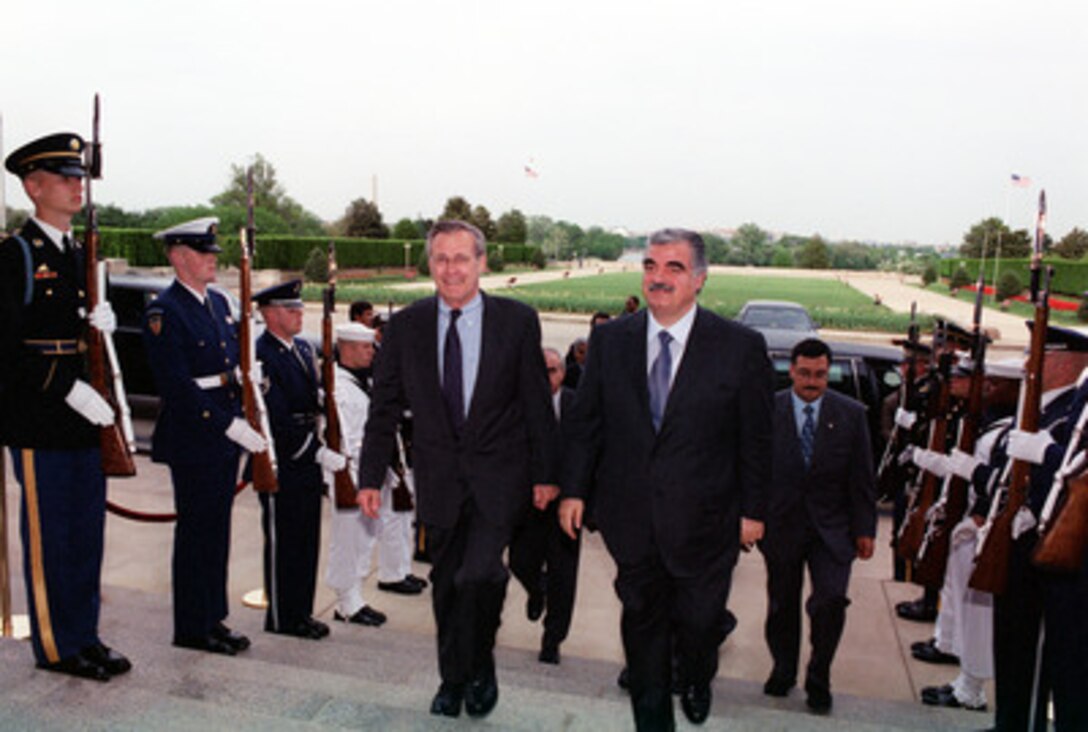 Secretary of Defense Donald H. Rumsfeld (left) escorts Lebanese Prime Minister Rafiq Hariri into the Pentagon on April 25, 2001. Rumsfeld and Hariri will meet to discuss a range of regional policy and security issues of interest to both nations. 
