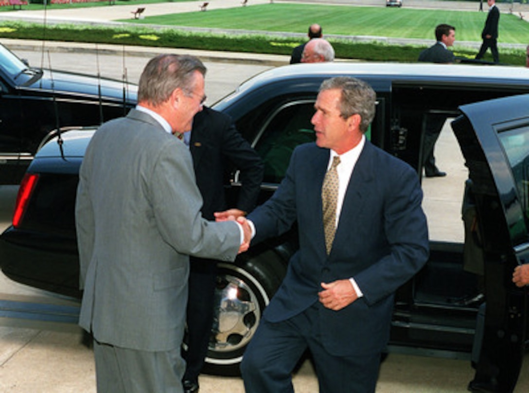 Secretary of Defense Donald H. Rumsfeld (left) welcomes President George W. Bush to the Pentagon on Aug. 1, 2001. The president will be given an update on the strategic review and force structuring issues. 