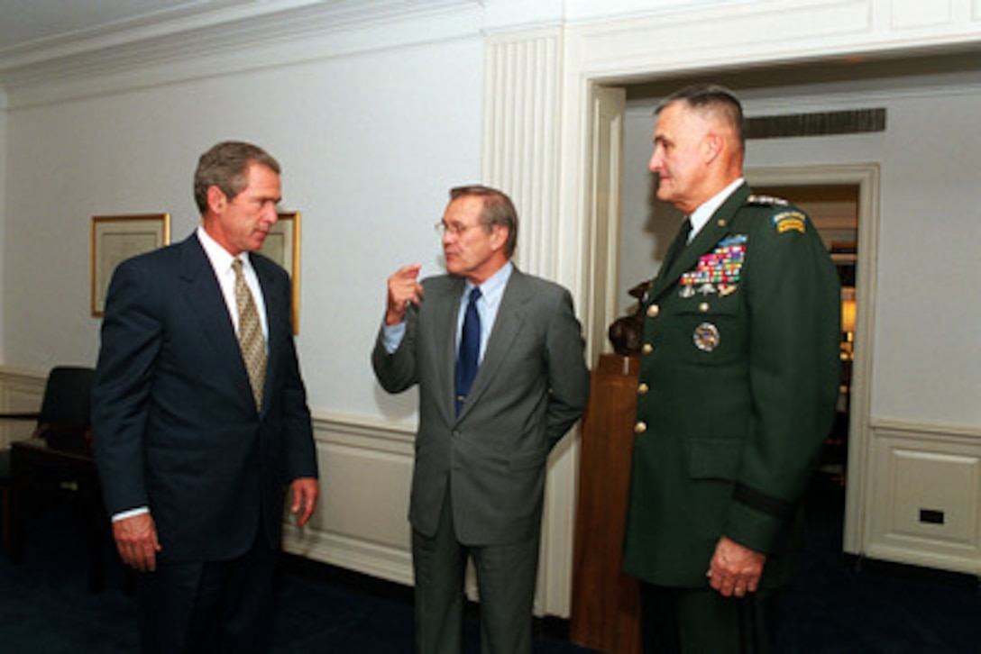 President George W. Bush, Secretary of Defense Donald H. Rumsfeld and Chairman of the Joint Chiefs of Staff Gen. Henry H. Shelton, U.S. Army, meet in Rumsfeld's Pentagon office on Aug. 1, 2001. Bush is at the Pentagon to receive an update on the strategic review and force structuring issues. 