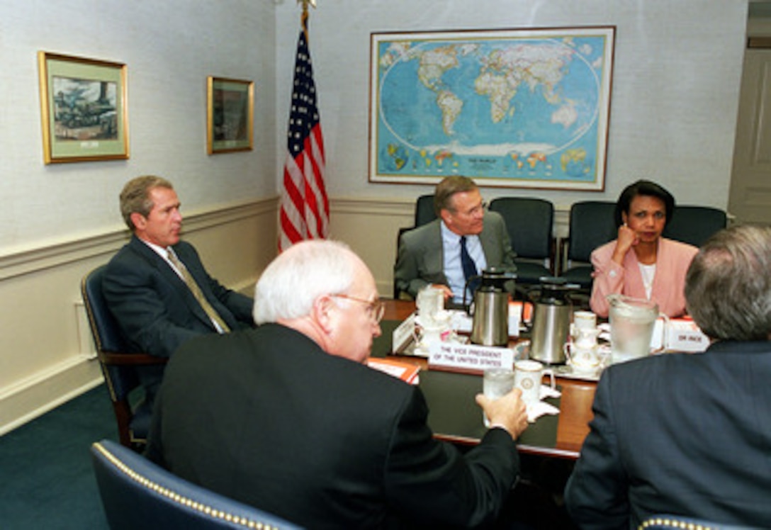 President George W. Bush (left), Vice President Dick Cheney (2nd from left), Secretary of Defense Donald H. Rumsfeld (3rd from left) and National Security Advisor Condolezza Rice prepare to receive a briefing in the Pentagon on Aug. 1, 2001. Bush and his staff are being provided an update on the strategic review and force structuring issues. 