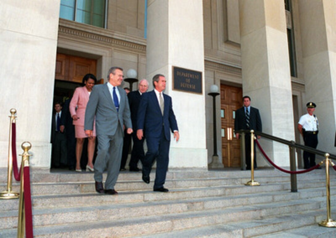 Secretary of Defense Donald H. Rumsfeld (second from left) escorts President George W. Bush (right), Vice President Dick Cheney (second from right) and National Security Advisor Condolezza Rice (left) out of the Pentagon on Aug. 1, 2001. Bush and his staff were provided an update on the strategic review and force structuring issues. 