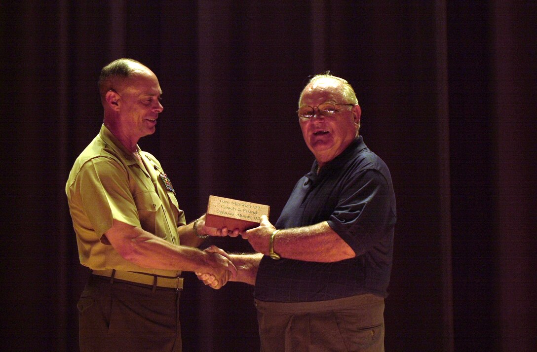 MARINE CORPS BASE CAMP LEJEUNE, N.C. - Maj. Gen. Robert C. Dickerson, the commanding general of Marine Corps Base Camp Lejeune, an award to Tom McGee here June 2. McGee was awarded the order of the Long Leaf Pine Award along with several other awards for his lasting contributions to the community in North Carolina. (Official U.S. Marine Corps photo by Lance Cpl. Brandon R. Holgersen)